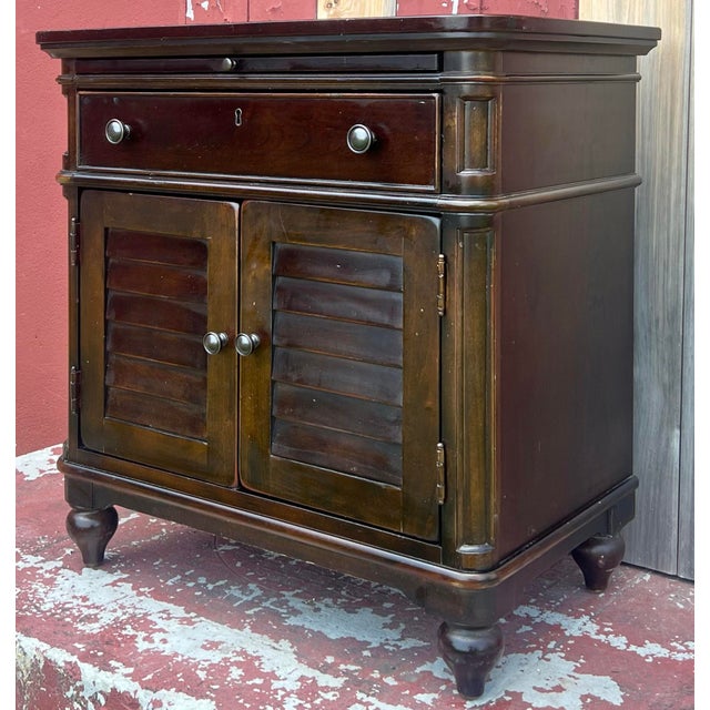 The Paula Deen Home Door nighstand in Tonacco finish. Crafted in Cherry with a dark walnut stain. Features single...