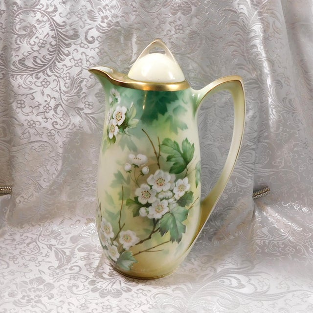 This is a Reinhold Schlegelmilch RS Germany chocolate pot that comes with four chocolate cups and two saucers. It has a...