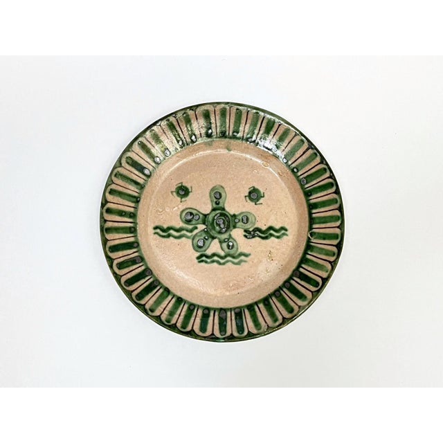 Four Vietri plates decorated in green with fish and caravels, Avallone Ceramics Factory, 1930s. The plates are part of a...