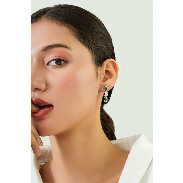 These elegant Drop earrings feature 1.66 carats of vibrant emeralds set in 14K white gold. Each emerald measuring 6 x 4...