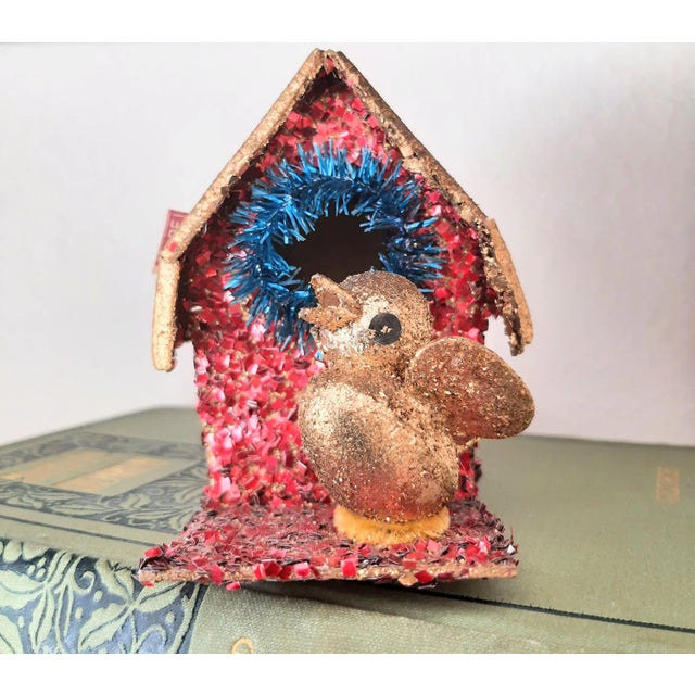 Step back in time with this dazzling Vintage Glitter Bird House Christmas Ornament, dating back to the fabulous 1930s!...