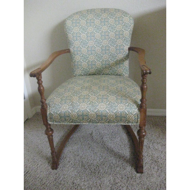 Classic vintage arm chair with upholstered seat and back. Lovely wood carved arms and legs in a light brown finish. The...