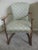 Classic vintage arm chair with upholstered seat and back. Lovely wood carved arms and legs in a light brown finish. The...