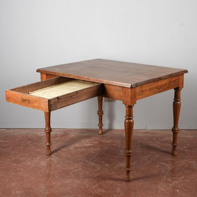 This solid wood table is a versatile piece that combines functionality with the classic aesthetic of vintage furniture....