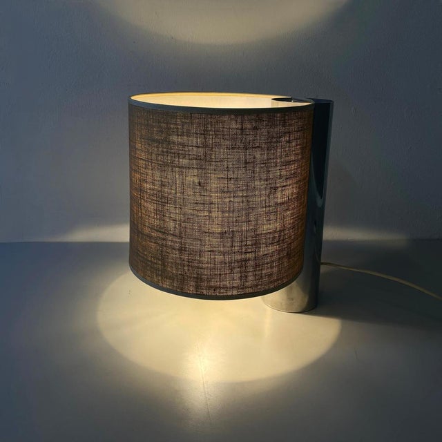 Fantastic and vintage table lamp mod. Fluette with double bulb and cylindrical lampshade in beige fabric with trimmings on...