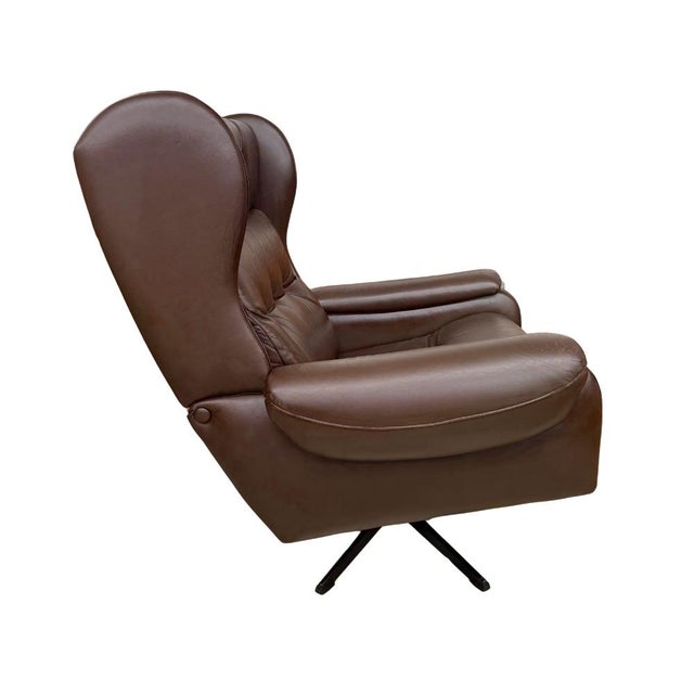 Rare vintage mid-century modern brown leather swivel armchair manufactured by Lystolet Möbler. Features a steel swivel...