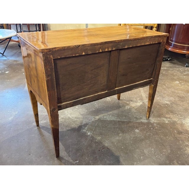 This 19th century walnut neoclassical inlaid 2 drawer table is a luxurious and stylish antique piece of furniture. The...