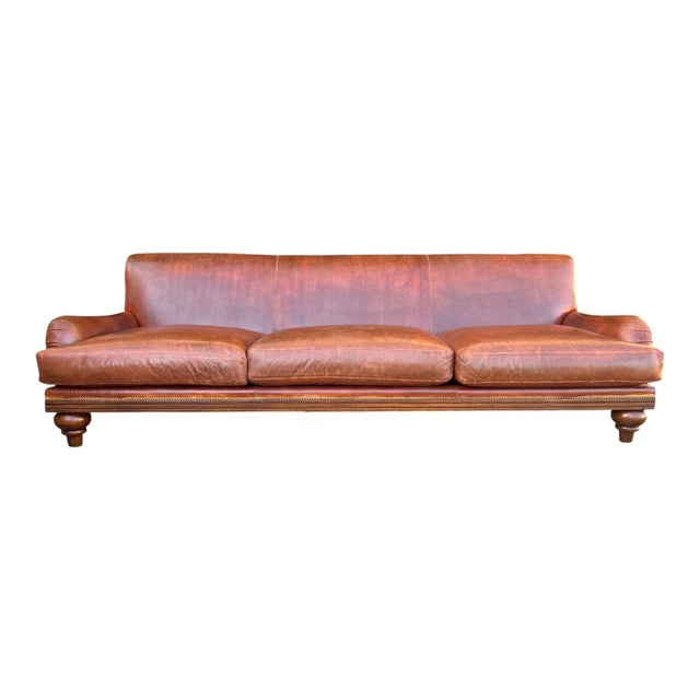 This substantial leather sofa combines timeless craftsmanship with inviting comfort and character. Upholstered in rich...