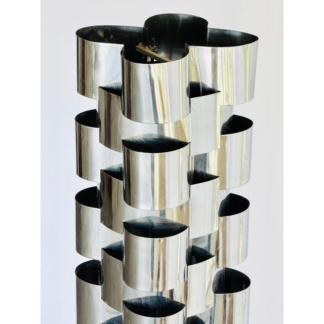 A polished steel floor lamp. Designed by Curtis Jere in the 70’s. Retains original brass label on base “ C Jere”. From a...