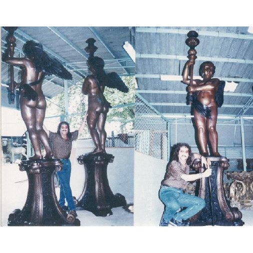 Bronze Massive Cupid Torchere Sculpture Pair (each sold separately) by the late Steven Bennett was cast by the...