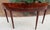This is an elegant Federal style mahogany console table with sunburst top and banded edge. The apron is a flame mahogany...