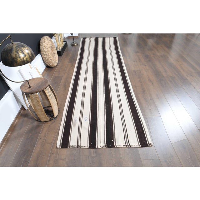 Vintage Hand-Knotted runner rug is a semi-antique vintage area rug. The '70s Eastern region of Anatolia's unique rug is...