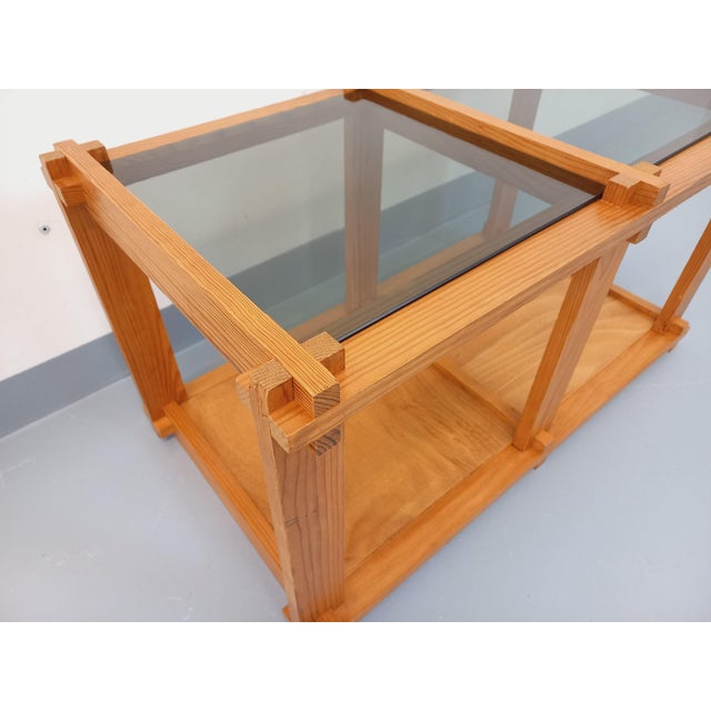 Vintage rectangular coffee table from the 1970s/80s, pine wood frame and magazine rack shelves, square smoked glass tops,...