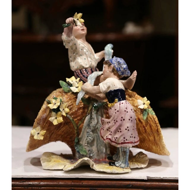 Decorate a shelf with this colorful antique Majolica sculpture composition. Created in France, circa 1920, the porcelain...