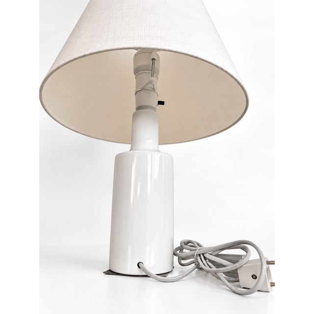 Elegant vintage porcelain table lamp by Royal Copenhagen, Denmark, dating from the Mid-Century period. The lamp features a...