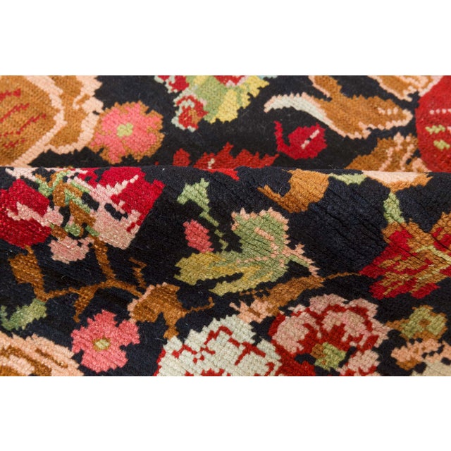This richly ornamental antique Karabagh rug is a vibrant example of early 20th-century Caucasian textile artistry...