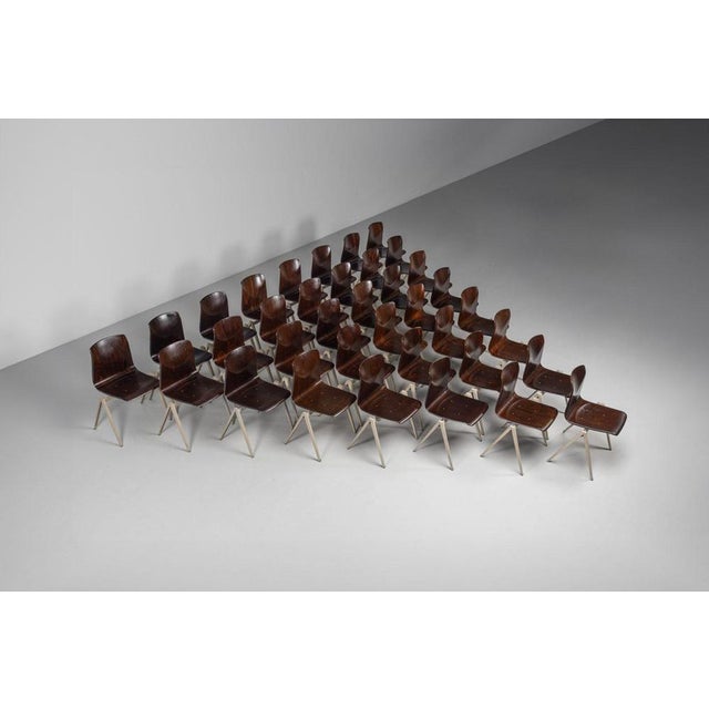 This expansive collection of s22 stacking chairs, designed by elmar flötotto and produced by pagholz in 1970, embodies the...