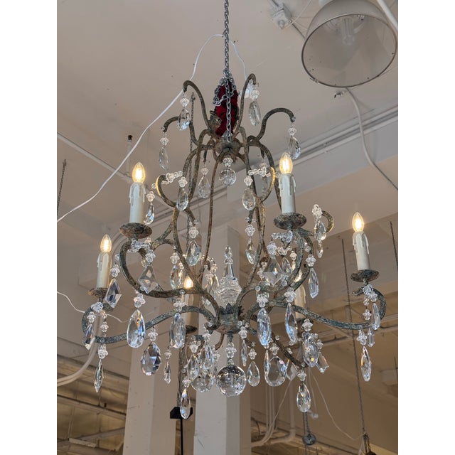 Design Plus Gallery presents the Chantilly Chandelier from Dennis & Leen. The hand-forged iron frame displays sweeping...
