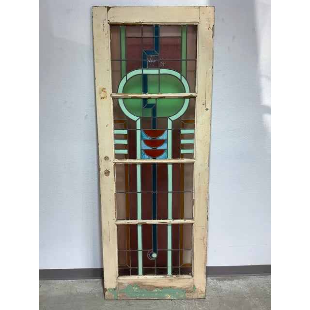 Stunning antique Art Deco stained glass door. Nicely detailed geometric design in blue, purple and green with red and...