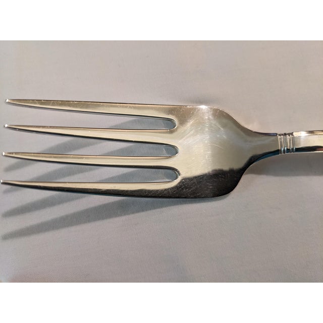 A sterling silver serving fork/cold meat fork by Tiffany in the simple but elegant "Windham" pattern, patented 1923,...