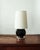Spherical table lamp in black glazed ceramic, resting on a chrome base. French work from the 1930s, in the style of...