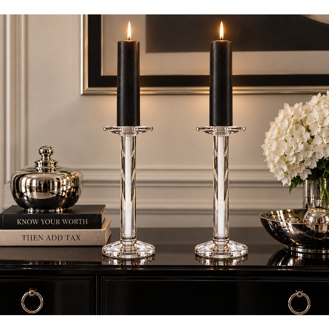 A striking pair of tall, clear crystal or art-glass candlesticks featuring a sleek architectural column silhouette. Each...