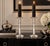 A striking pair of tall, clear crystal or art-glass candlesticks featuring a sleek architectural column silhouette. Each...