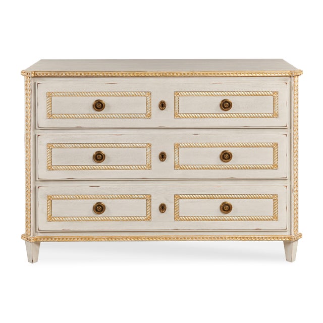 White wash finish case with gold leaf accents on Acacia solids. Six soft-close drawers with antique brass hardware