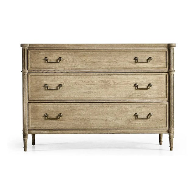 French Louis XVI Style Commode, made with chestnut in a natural stripped finish that marries effortlessly with custom-cast...