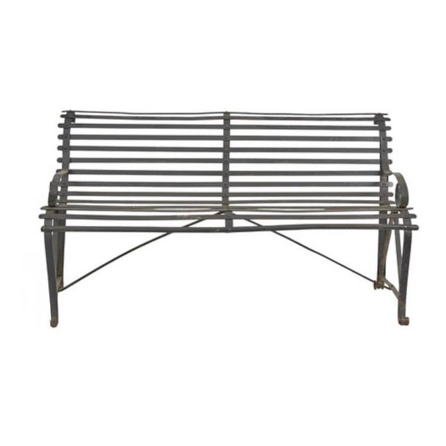 Black Painted Iron Garden Bench. Bench features curved slatted back and seat framed by hand-forged scroll armrests....