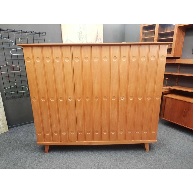 A very beautiful china and linen cabinet by Rudolf Frank. Designed in 1955, manufactured by Erwin Behr, Germany. The...