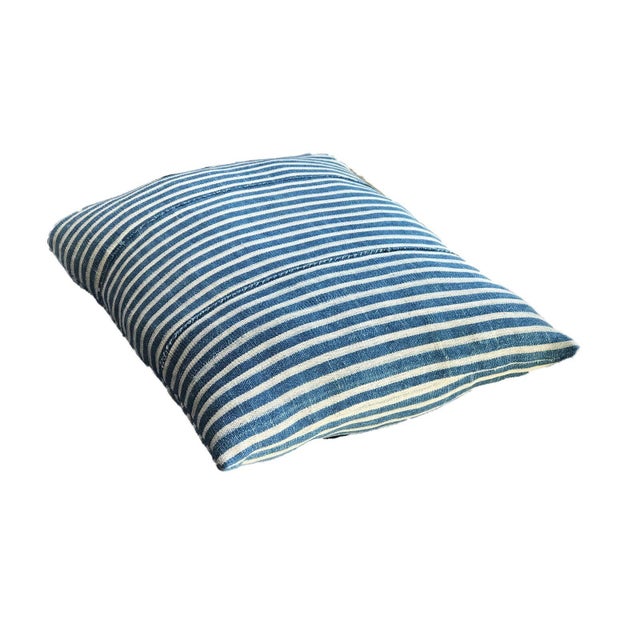 Authentic vintage blue and white cotton lumbar pillow handcrafted in Bondoukou, Ivory Coast. Features striking indigo and...