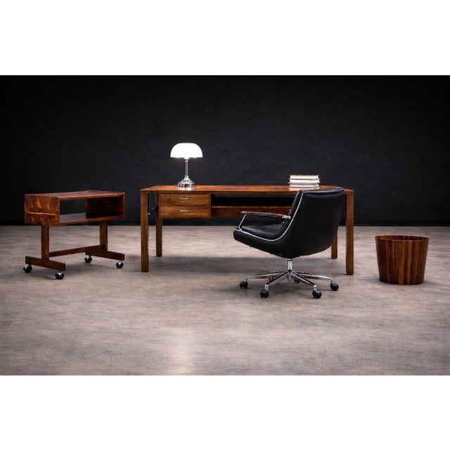 This mid-century console is executed in Brazilian rosewood (jacarandá), combining solid construction with richly figured...