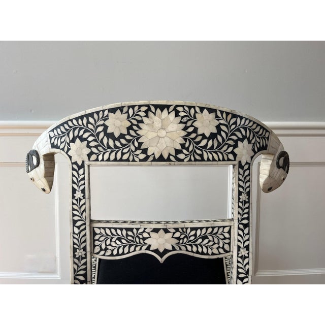 Extraordinary set of four Anglo-Indian side chairs with ram's head bone inlay and solid black seats. These black and white...