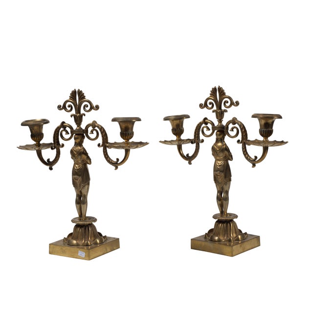 Pair of candleholders realized at the end of the 19th century by French manufacture. The artwork has two arms in gilded...