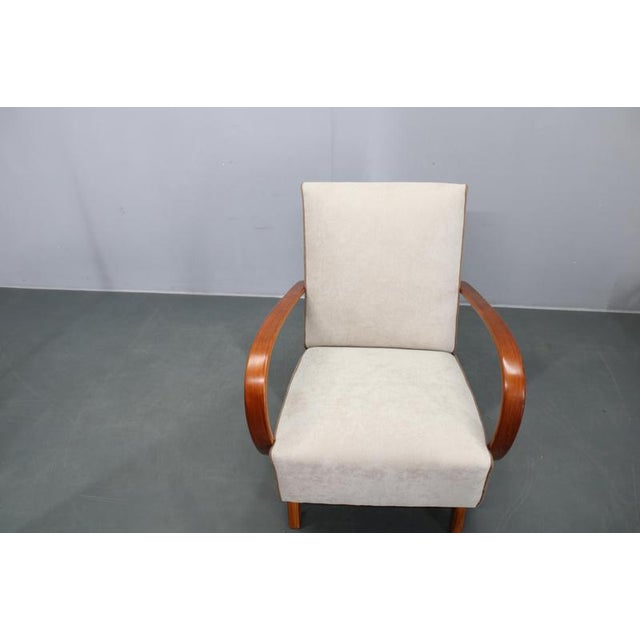 This refined Art Deco armchair was designed by Jindřich Halabala and produced in Czechoslovakia in the 1940s. Crafted from...