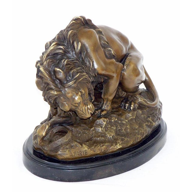 Art Deco style brown patinated bronze lion sculpture. This bronze animal statue represents a lion fighting a snake,...