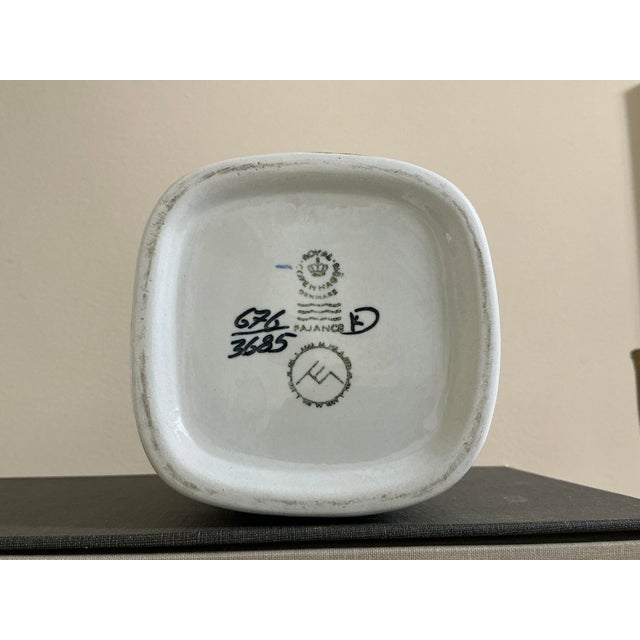 This striking rare square-format vase is a prime example of Danish Mid-Century Modern ceramic art. Part of the "Baca"...