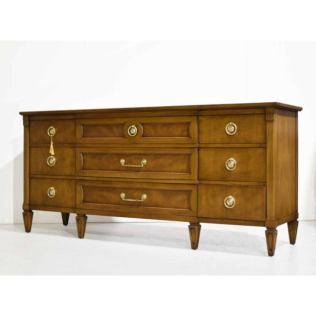 Timeless design and exceptional craftsmanship define this Mid Century Transitional Dresser or Sideboard by Henredon...