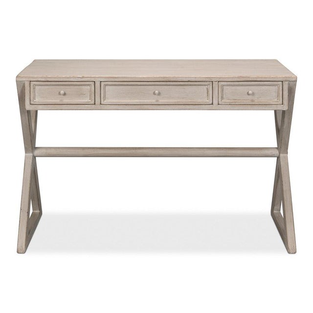 Crossed supports recall the portable forms of officers' furniture and give the writing surface a distinct stance. Between...