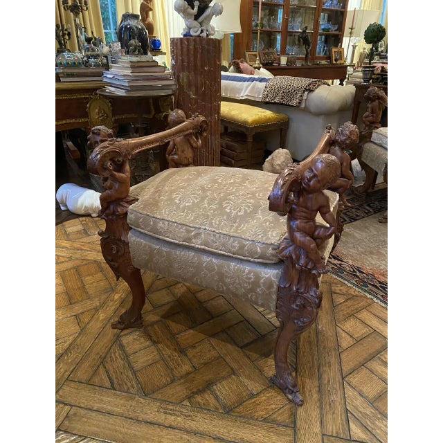 This is an Italian Baroque style carved bench in the manner of Andrea Brustolon. Each carved armrest is supported by a...