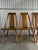 A beautifully handcrafted set of four solid maple dining chairs, blending rustic charm with streamlined mid-century...