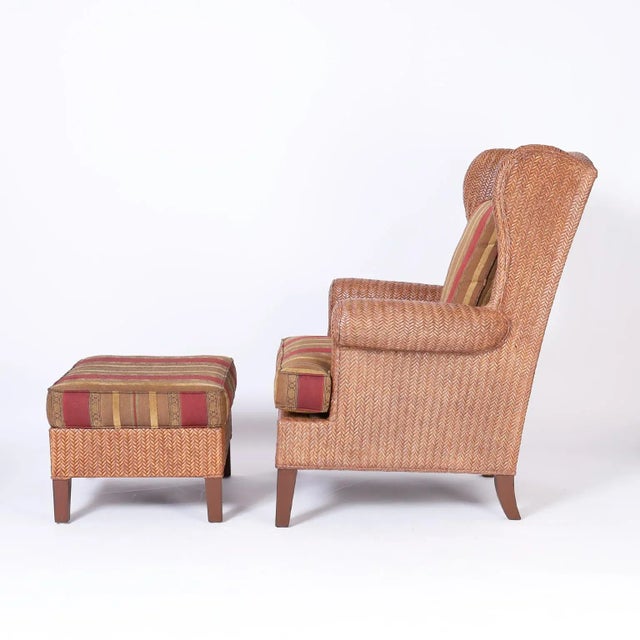 Handsome vintage British colonial style wingback armchair and ottoman with a classic form crafted in herringbone woven...