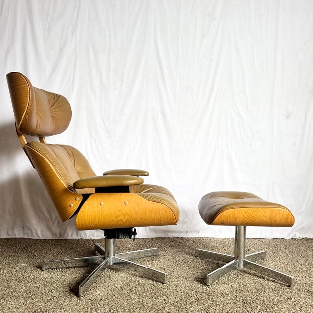 This mid-century modern Eames-style lounge chair and ottoman feature sculpted bentwood shells, supple tufted faux leather...