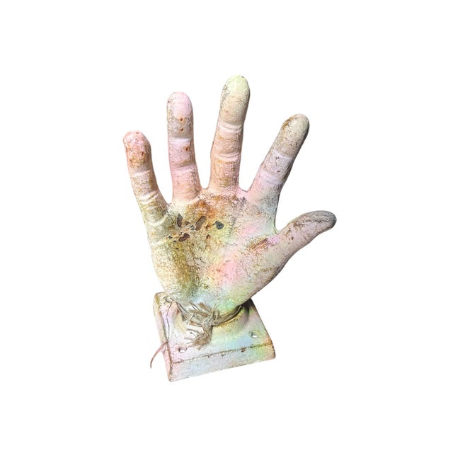 Base of the hand has four holes for mounting to wall or tabletop. Hand is the size of small adult hand.. Hand does adjust...