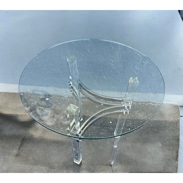 Lucite side table with chrome plated hardware. It is in very good condition. The glass has a little chip (see picture)....