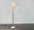 Italian floor lamp with a special base and shade. The special detail of this lamp is the elaborate glass shade. The glass...