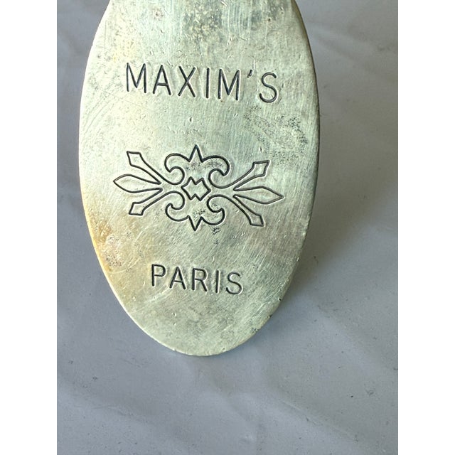 A chic piece of Parisian dining history — a brass key fob from the legendary Maxim's de Paris, one of the world's most...