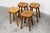 Set of four handcrafted, Brutalist-style stools from the 1960s, each featuring a carved flower on the top. These four...