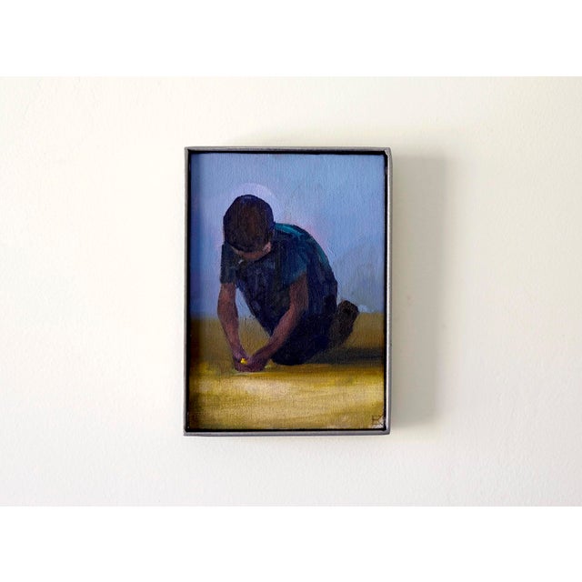 This oil on canvas panel depicts a young boy kneeling on the ground, absorbed in play as he focuses on a small object in...